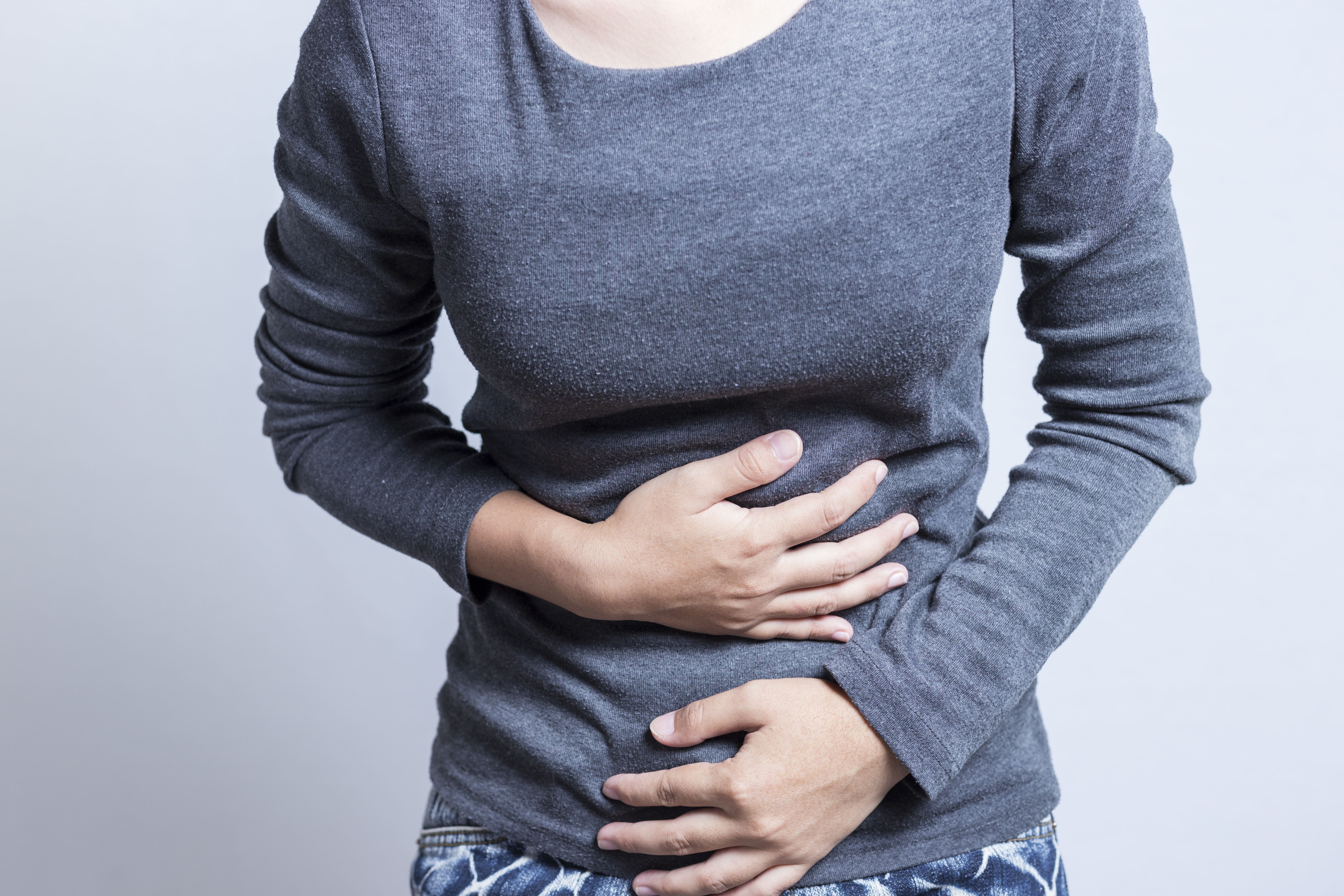 Woman holding abdomen in pain